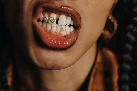 Gold Logo-Adorned Tooth Gems