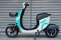 Crowded Cityscape Electric Bicycles Image 2