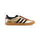 Collaborative Gold-Toned Sneakers Image 1