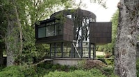 Round Glass-Wrapped Lakeside House Image 1
